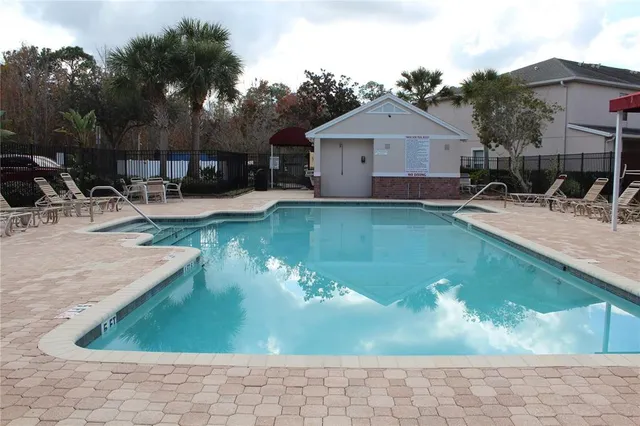 an outdoor space with swimming pool and furniture