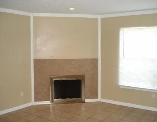 a view of an empty room with a fireplace