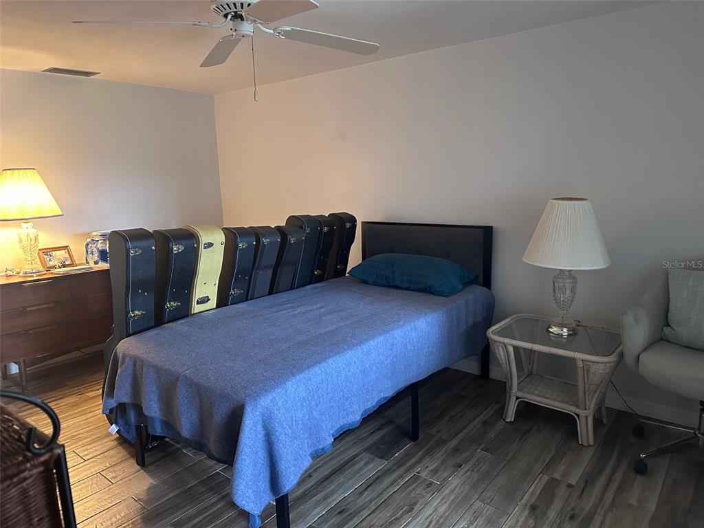 3542 Delta Place Holiday, FL 34691 - Photo 22 of 28 a bed room with a bed and a lamp