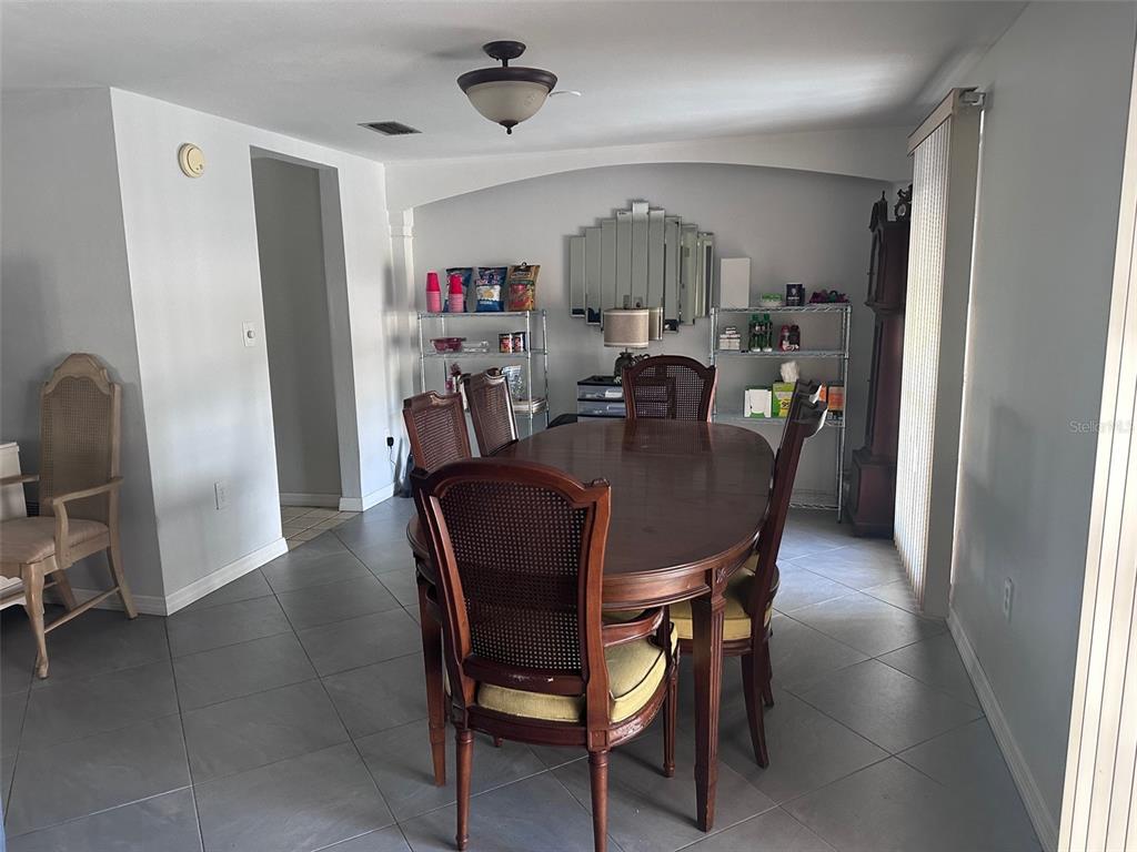 3542 Delta Place Holiday, FL 34691 - Photo 26 of 28 a view of a dining room with furniture and a chandelier