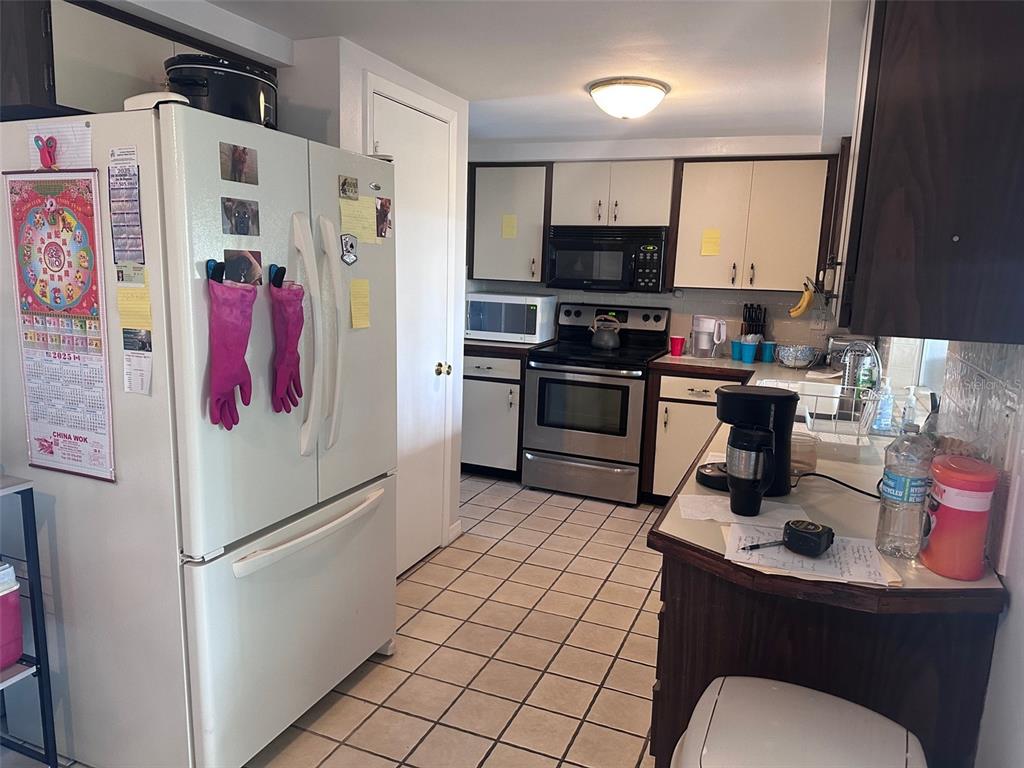 3542 Delta Place Holiday, FL 34691 - Photo 5 of 28 a kitchen with stainless steel appliances a refrigerator sink and microwave