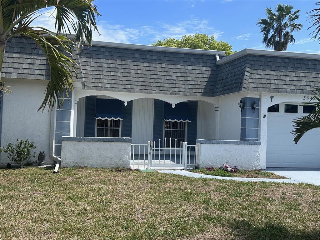 3542 Delta Place Holiday, FL 34691 - Photo 6 of 28 a front view of a house with garden