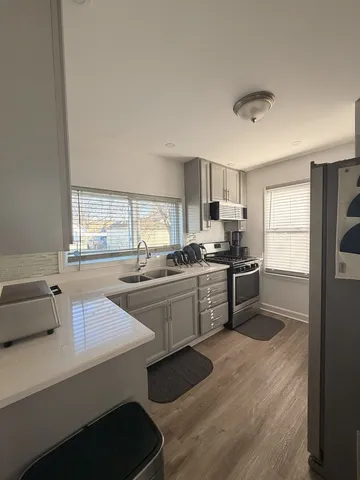 a kitchen with a stove a sink and a microwave