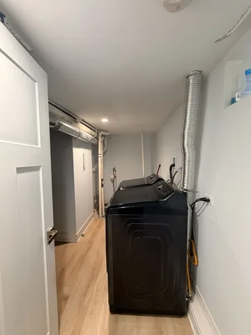 a bathroom with a tub sink and mirror