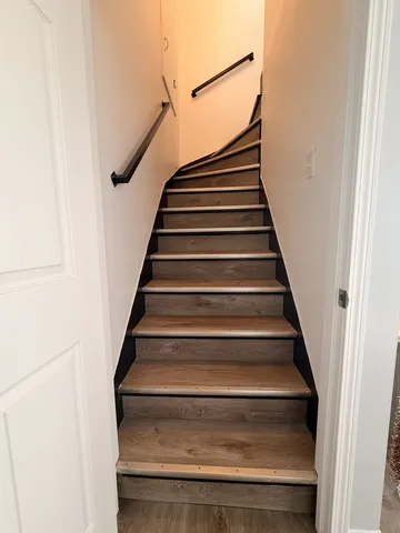 a spacious bedroom with a bed and a view of living room