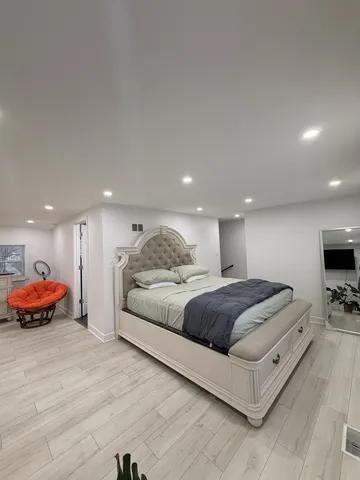 a room with a bed furniture and a flat screen tv