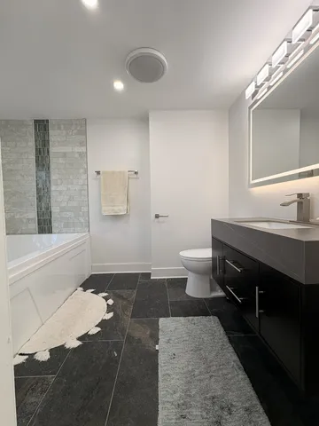 a bath tub sitting in a bathroom next to a window