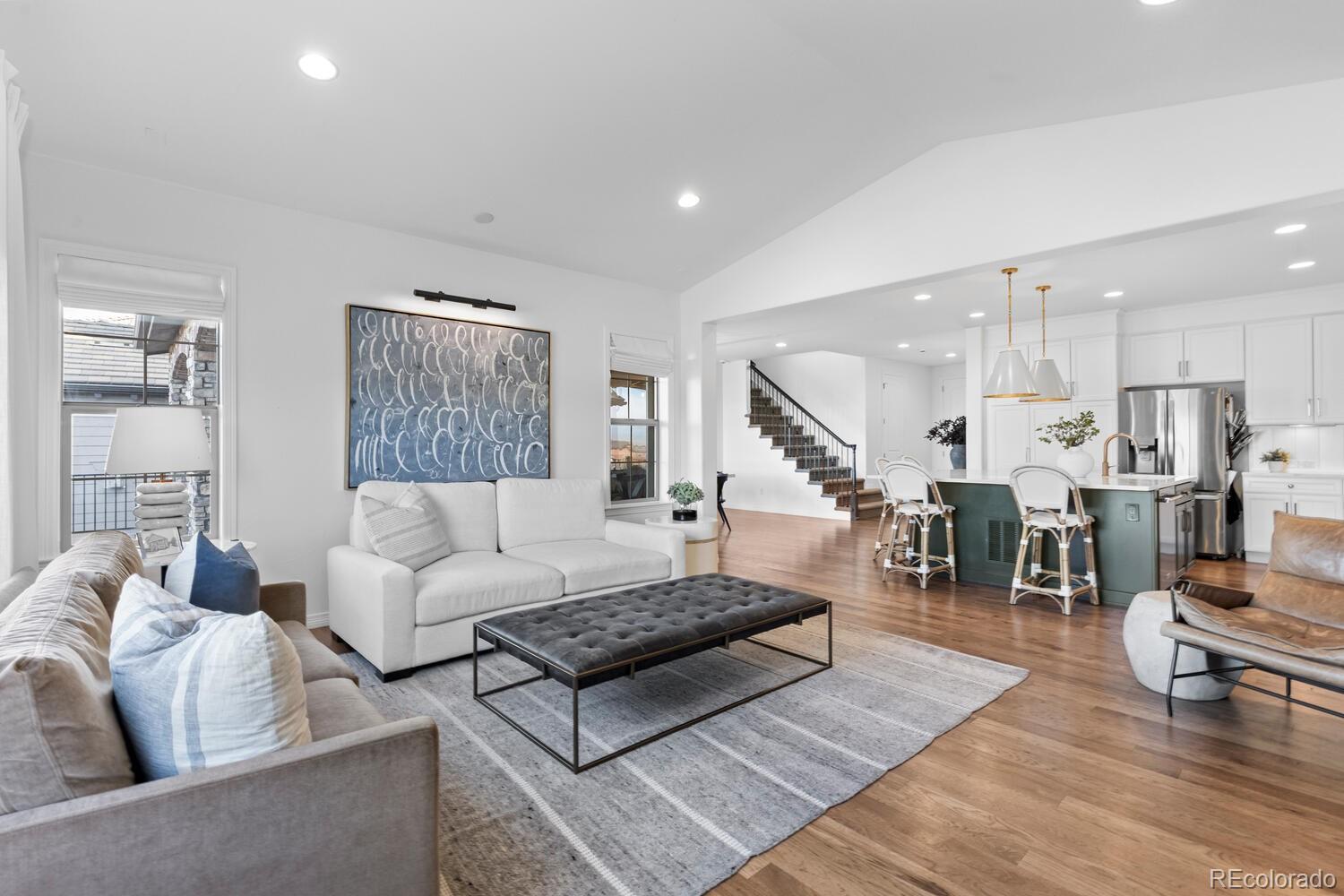 10699 Timberdash Avenue Highlands Ranch, CO 80126 - Photo 12 of 50 a living room with furniture kitchen view and a wooden floor