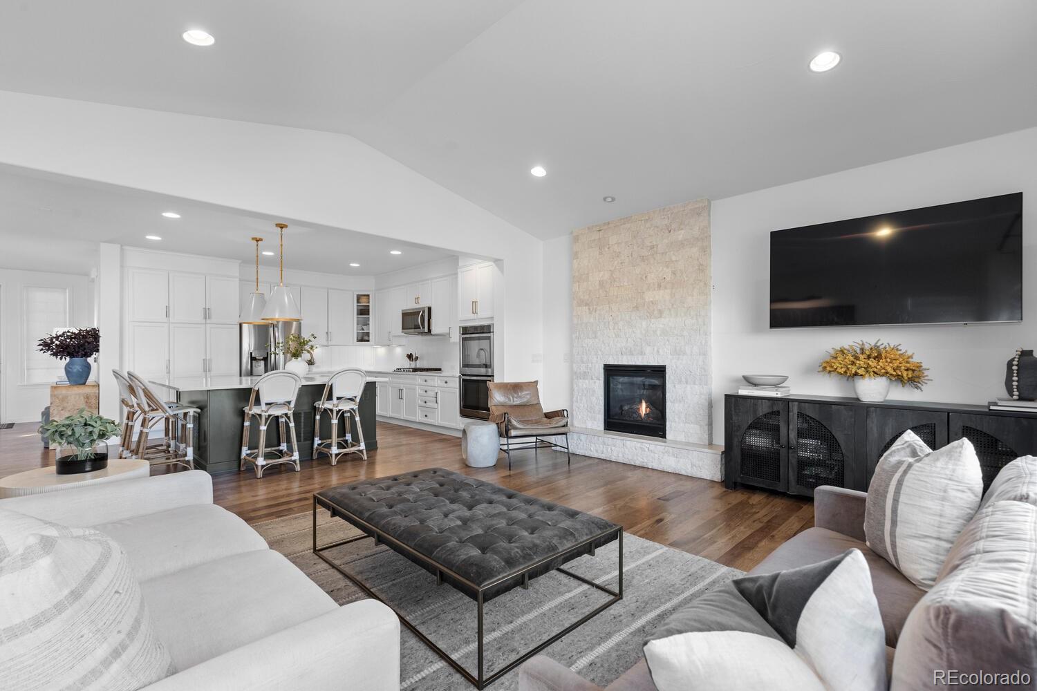 10699 Timberdash Avenue Highlands Ranch, CO 80126 - Photo 13 of 50 a living room with furniture a flat screen tv and a fireplace