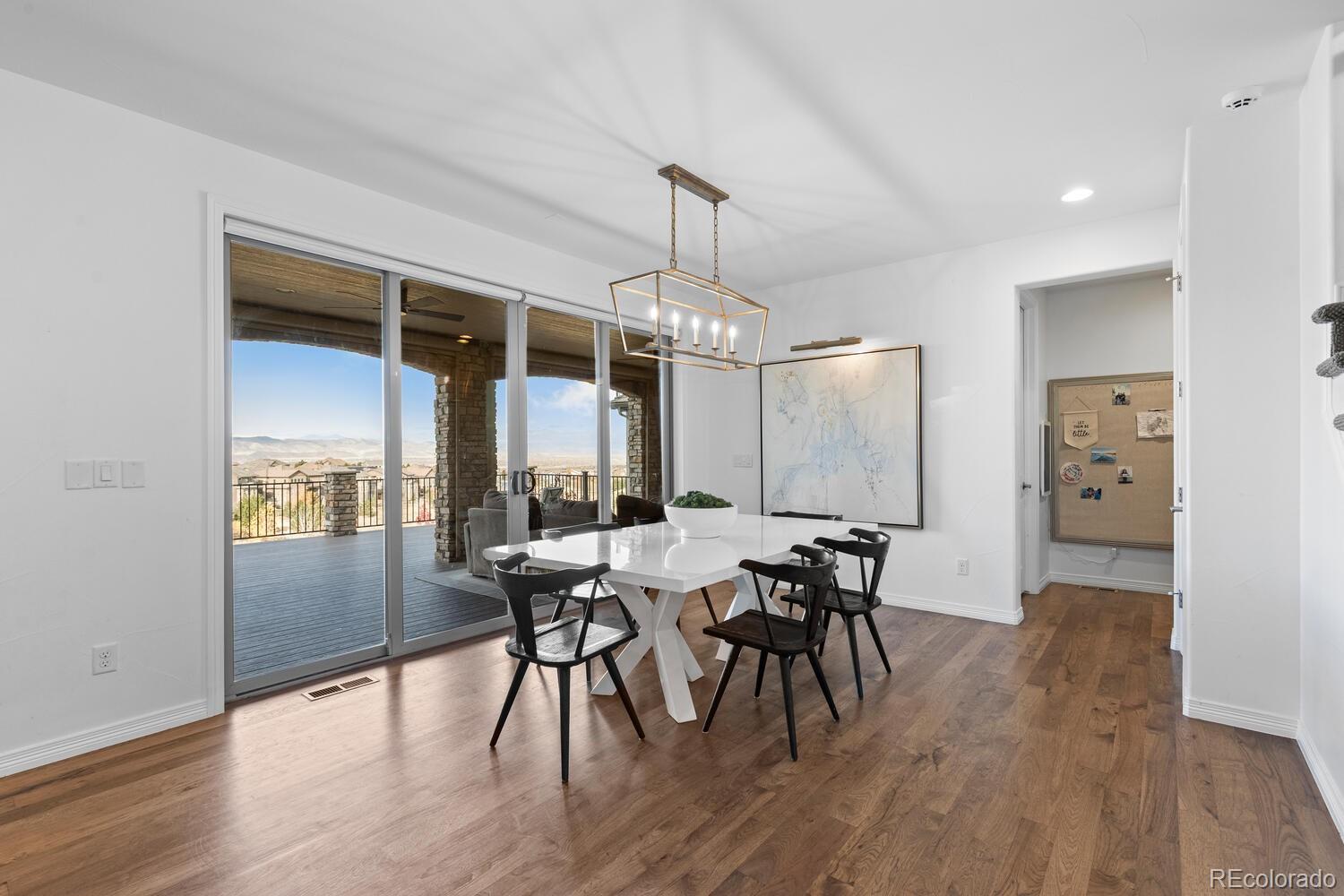 10699 Timberdash Avenue Highlands Ranch, CO 80126 - Photo 14 of 50 a view of a dining room with furniture window and wooden floor