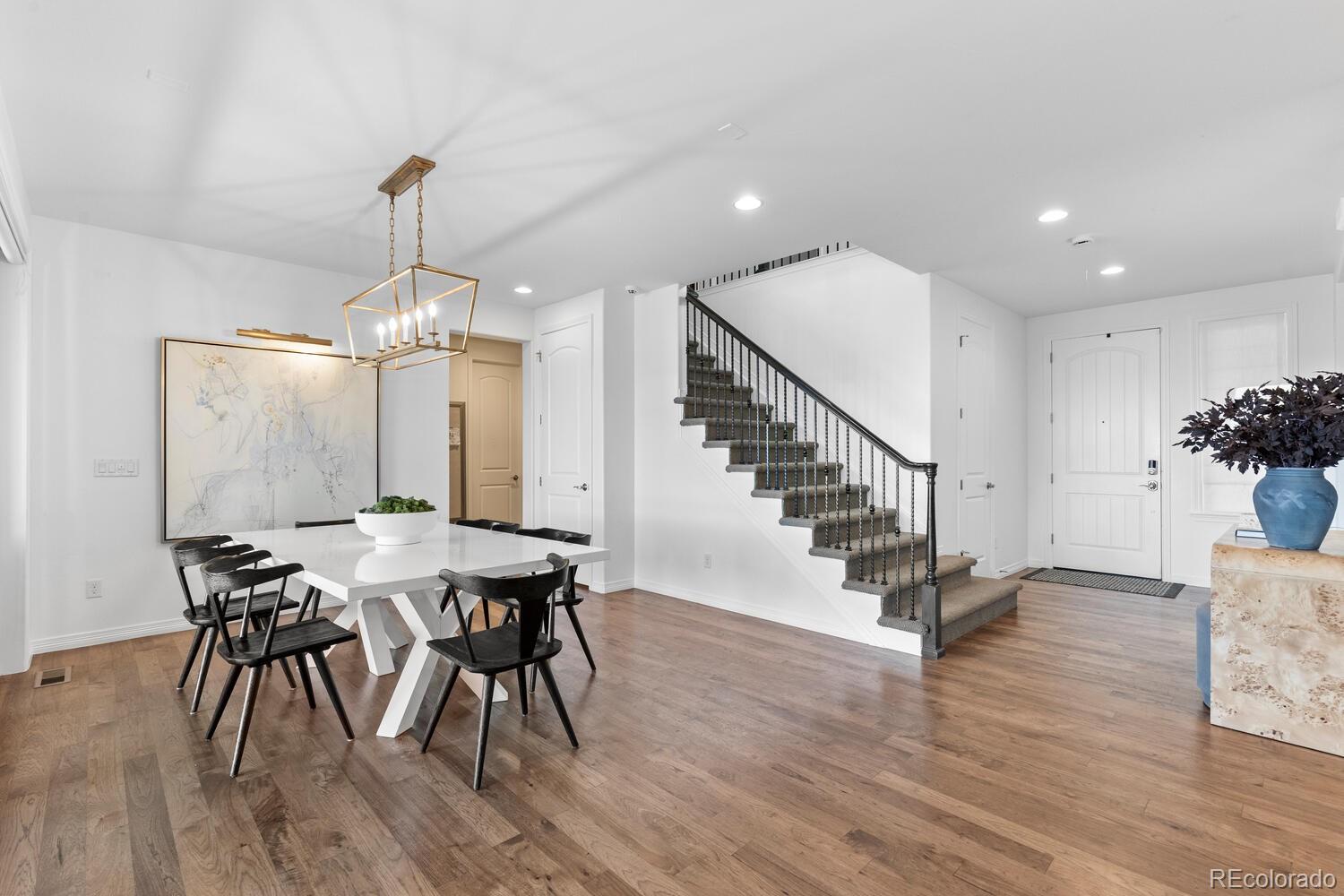 10699 Timberdash Avenue Highlands Ranch, CO 80126 - Photo 16 of 50 a view of a dining room with furniture wooden floor and chandelier