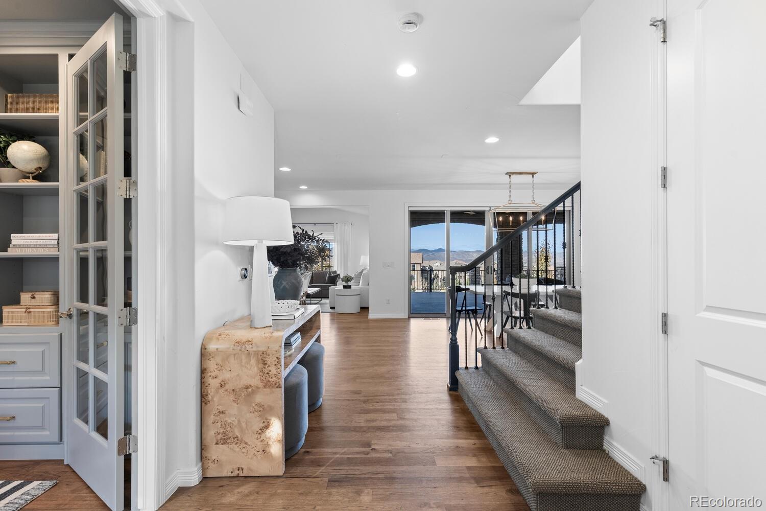 10699 Timberdash Avenue Highlands Ranch, CO 80126 - Photo 20 of 50 a dining room with furniture and wooden floor