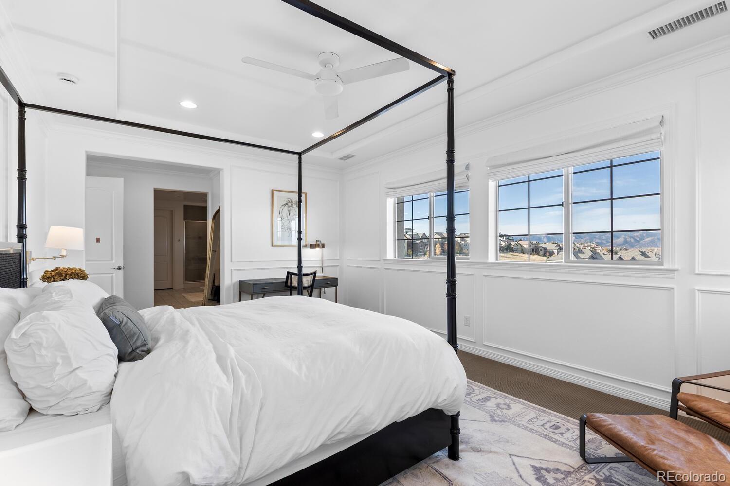 10699 Timberdash Avenue Highlands Ranch, CO 80126 - Photo 25 of 50 a bedroom with a bed window and wall painting