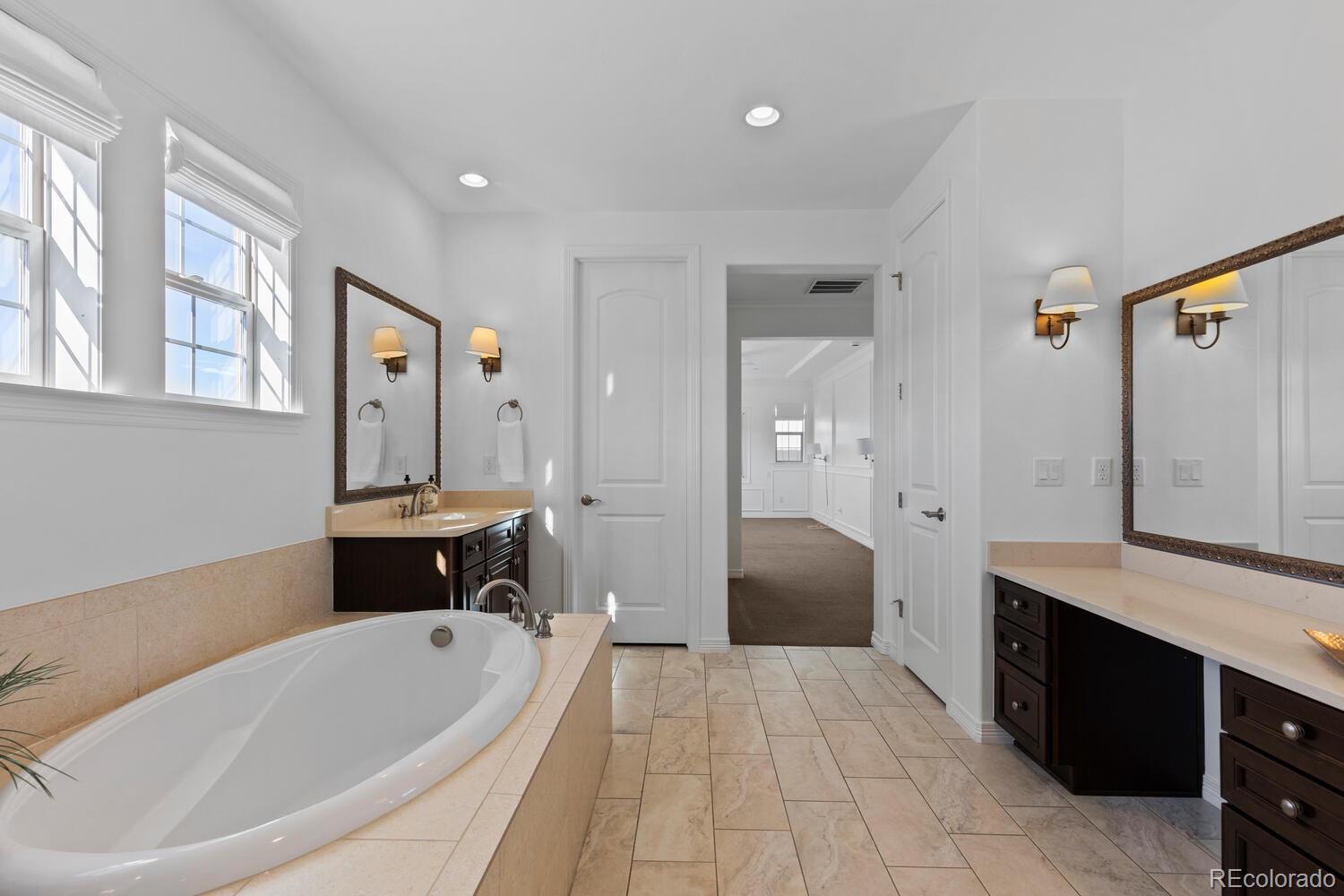 10699 Timberdash Avenue Highlands Ranch, CO 80126 - Photo 28 of 50 a spacious bathroom with a tub sink and mirror