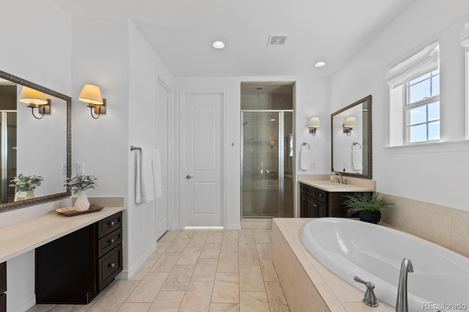 10699 Timberdash Avenue Highlands Ranch, CO 80126 - Photo 29 of 50 a spacious bathroom with a bathtub sink and mirror