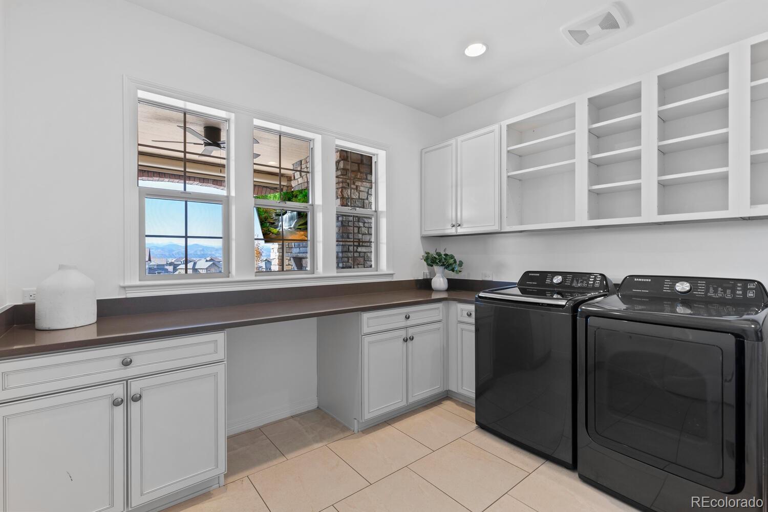10699 Timberdash Avenue Highlands Ranch, CO 80126 - Photo 30 of 50 a kitchen with granite countertop a sink stainless steel appliances and cabinets