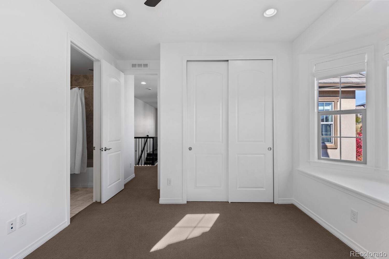 10699 Timberdash Avenue Highlands Ranch, CO 80126 - Photo 40 of 50 an empty room with windows and closet