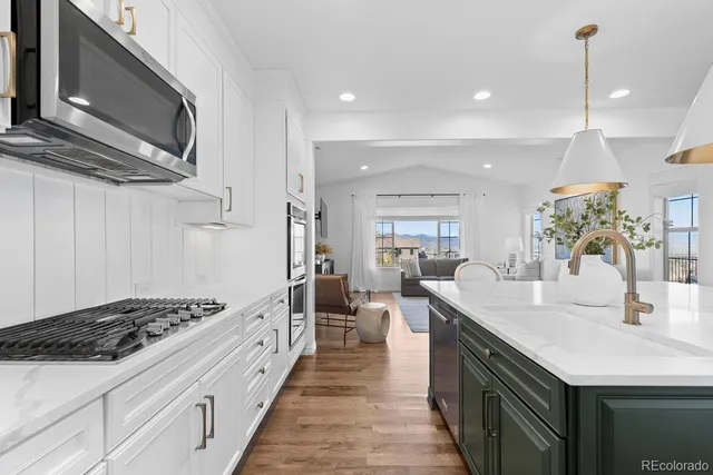 a open kitchen with stainless steel appliances granite countertop a sink stove and cabinets