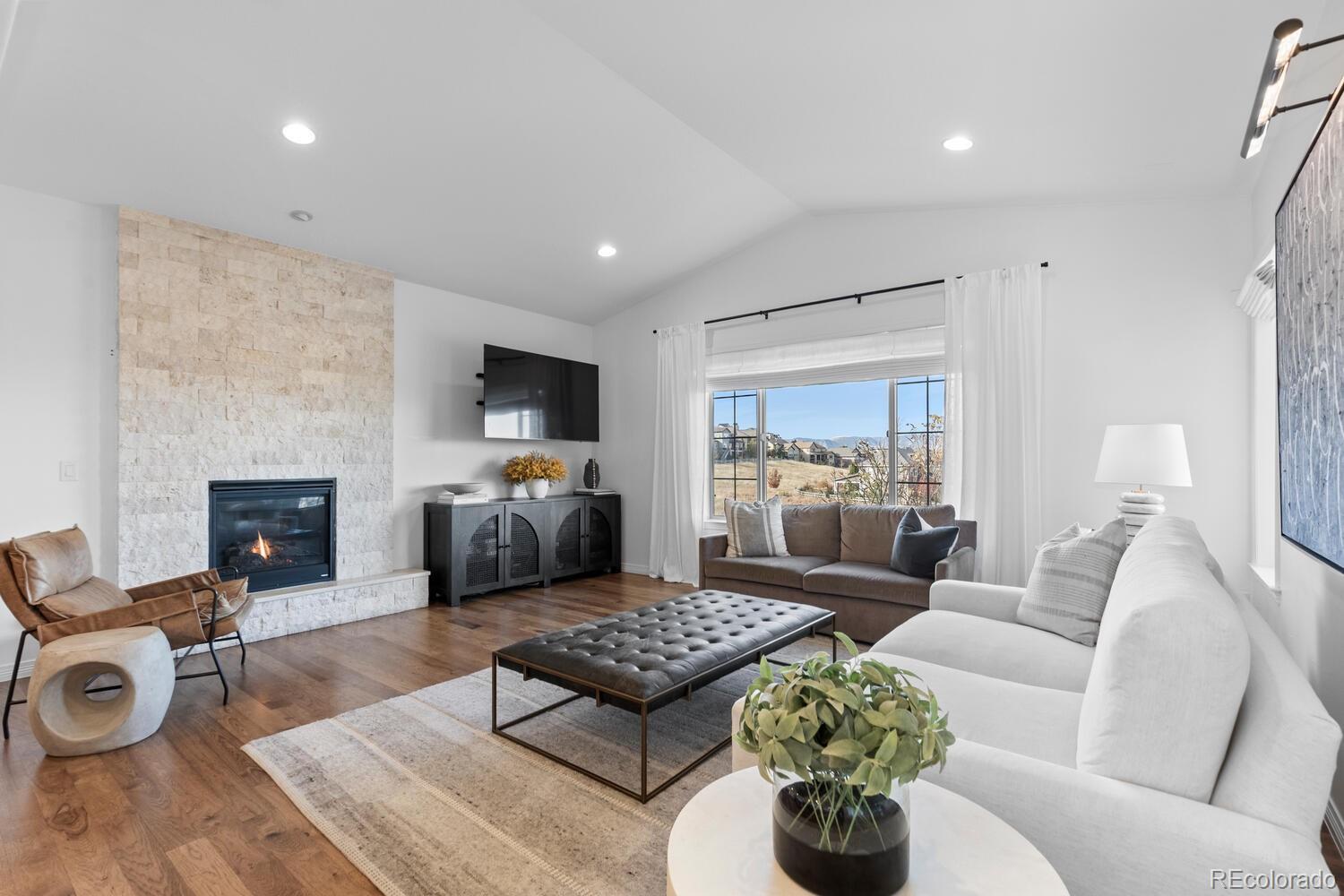 10699 Timberdash Avenue Highlands Ranch, CO 80126 - Photo 9 of 50 a living room with furniture fireplace and a fireplace