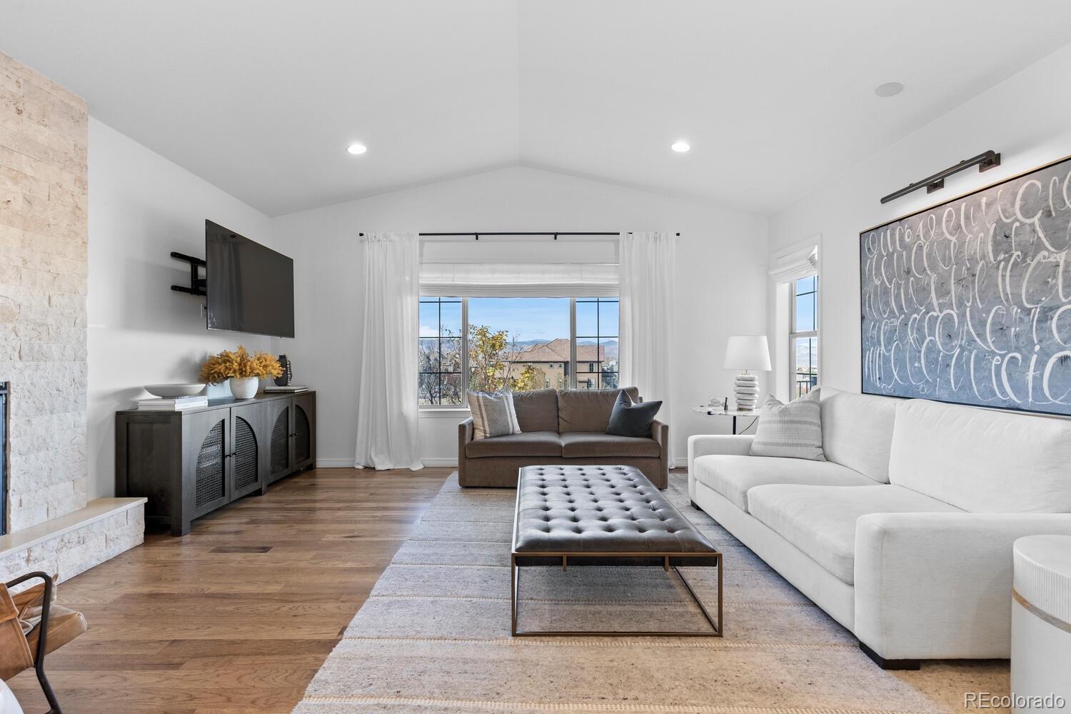 10699 Timberdash Avenue Highlands Ranch, CO 80126 - Photo 10 of 50 a living room with furniture and a flat screen tv