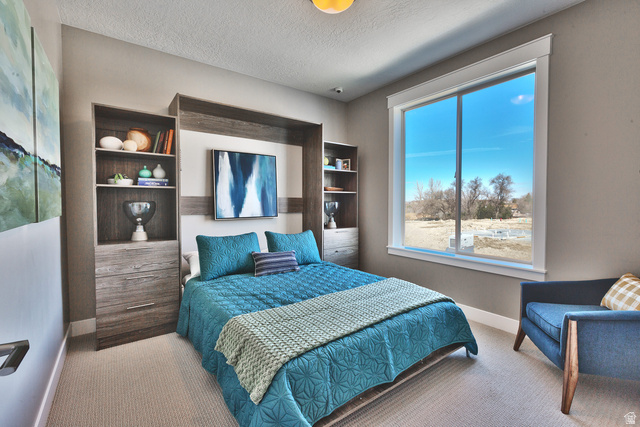 252 East Sandy Sage Way Sandy, UT 84070 - Photo 26 of 36 Bonus Bedroom; can be Office/Den with large window with ample natural light, recessed ceiling light fixture, and light-toned carpeting