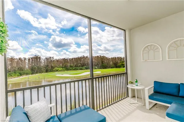 a view of a chair and tables in the balcony