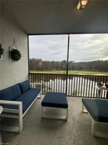 a balcony with wooden floor and outdoor seating