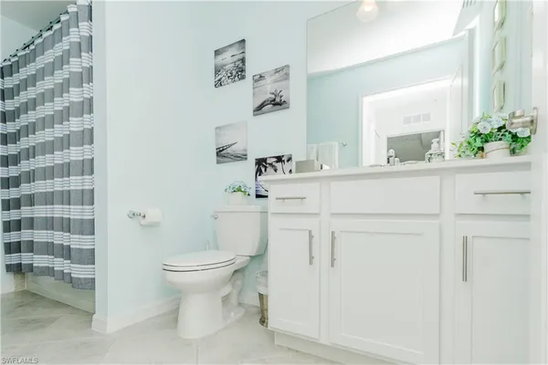 a bathroom with a tub shower vanity and a sink