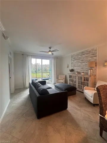 a living room with furniture and large windows
