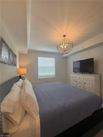 a bedroom with a bed and a television