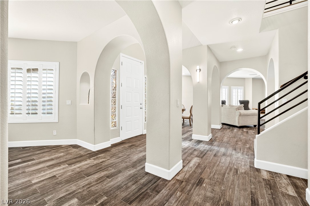 1135 Calico Ridge Drive Henderson, NV 89011 - Photo 12 of 86 Architectural arches and rich wood-look porcelain tile flooring welcome you into this inviting home.