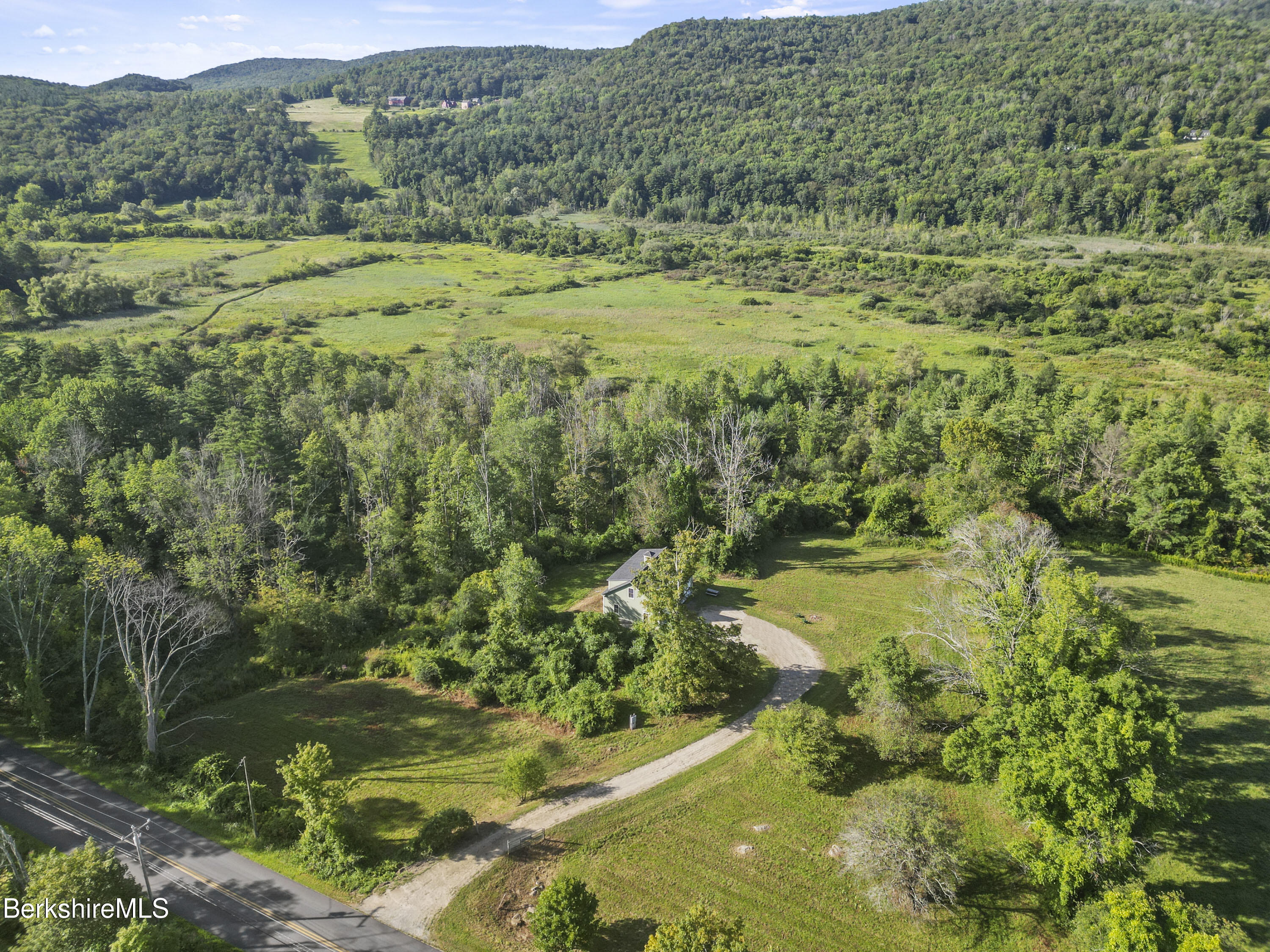 48 Main Road Tyringham, MA 01238 - Photo 2 of 25 a view of a lush green forest with lots of trees
