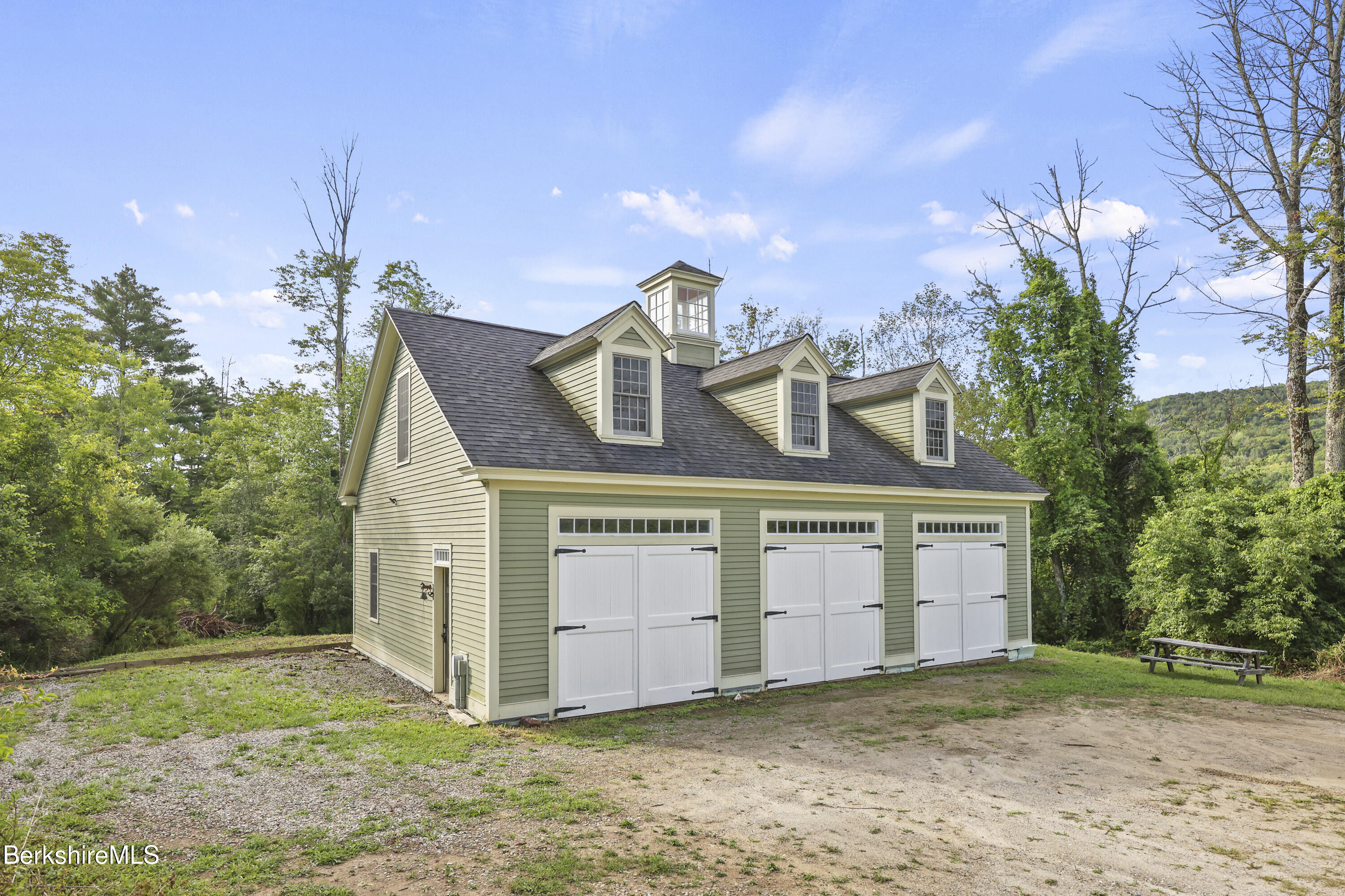 48 Main Road Tyringham, MA 01238 - Photo 8 of 25 a view of a house with a yard and potted plants