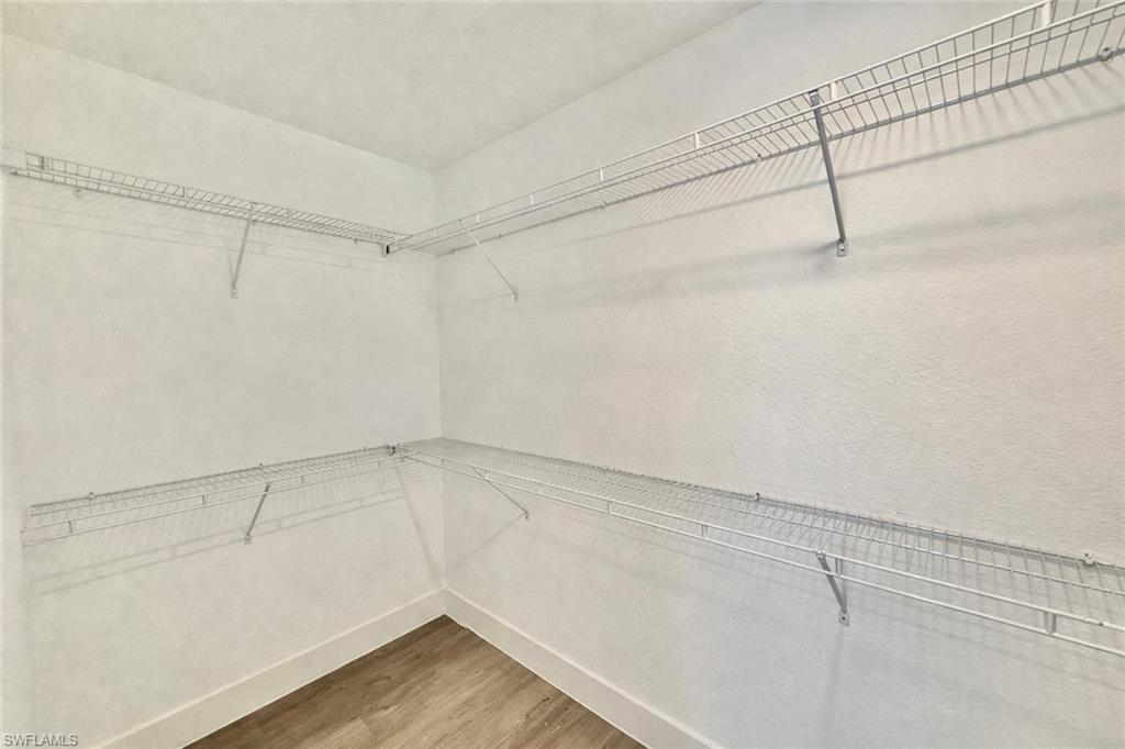 2709 22nd Street Southwest Lehigh Acres, FL 33976 - Photo 10 of 18 a view of a room with racks on the wall