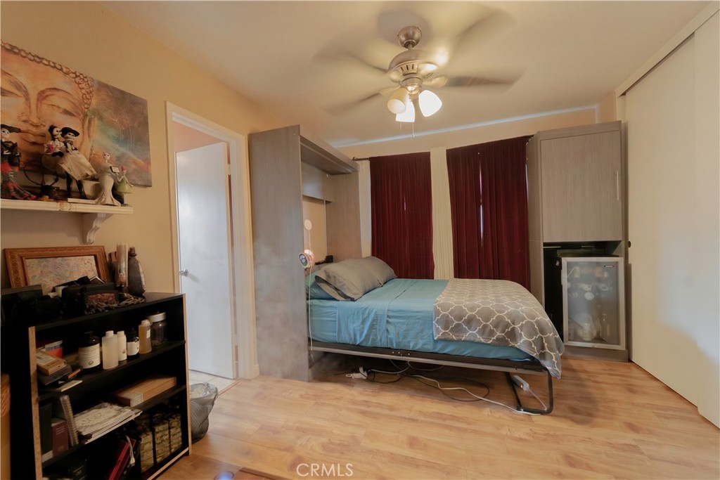 9221 Pico Vista Road Downey, CA 90240 - Photo 11 of 38 a bedroom with a bed and a chandelier