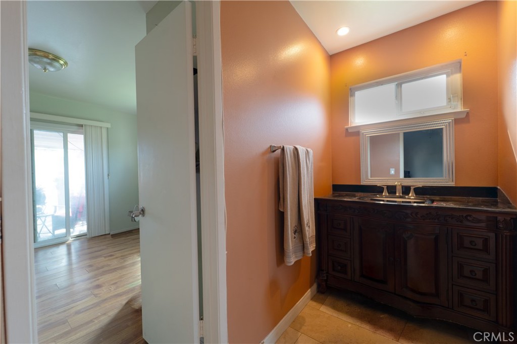 9221 Pico Vista Road Downey, CA 90240 - Photo 13 of 38 a view of a hallway with wooden floor and a bathroom
