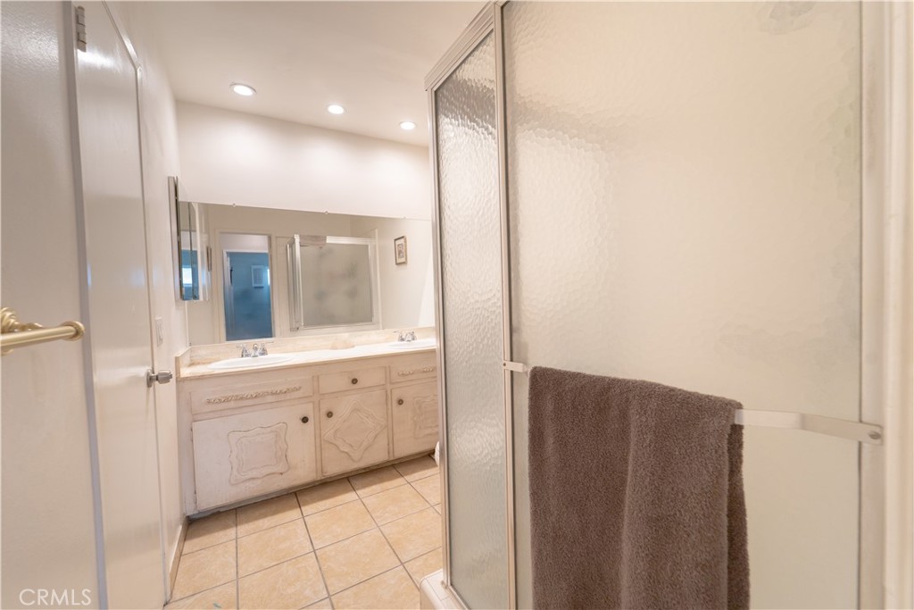 9221 Pico Vista Road Downey, CA 90240 - Photo 15 of 38 a bathroom with a sink a mirror and a bathtub