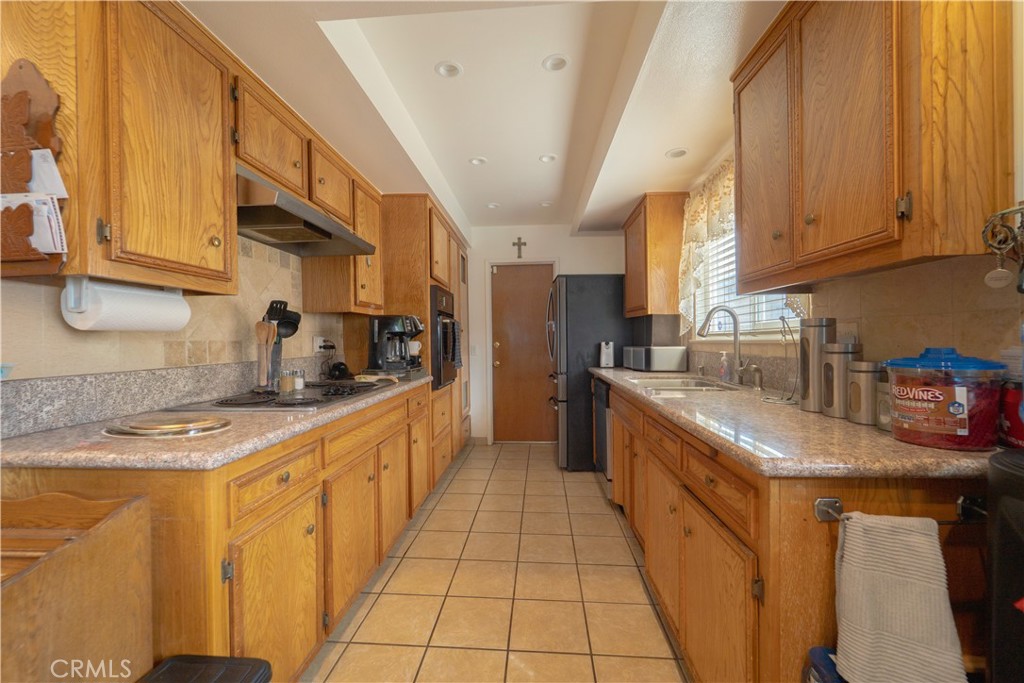 9221 Pico Vista Road Downey, CA 90240 - Photo 19 of 38 a kitchen with stainless steel appliances granite countertop a sink and cabinets