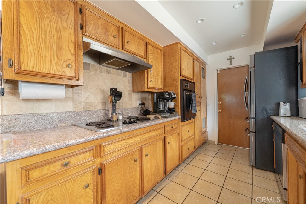 9221 Pico Vista Road Downey, CA 90240 - Photo 20 of 38 a kitchen with stainless steel appliances granite countertop a refrigerator and a sink