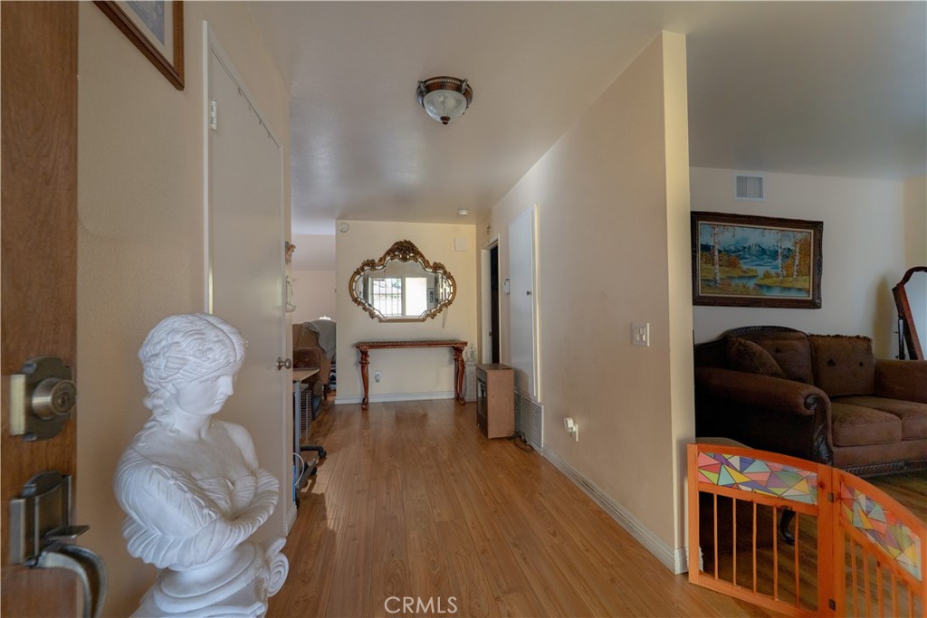 9221 Pico Vista Road Downey, CA 90240 - Photo 2 of 38 a living room with furniture and a wooden floor