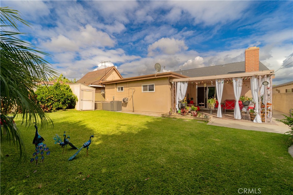 9221 Pico Vista Road Downey, CA 90240 - Photo 22 of 38 a view of a backyard with table and chairs and potted plants