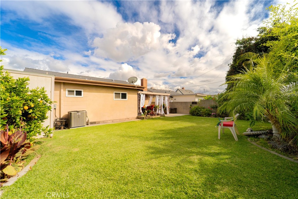 9221 Pico Vista Road Downey, CA 90240 - Photo 23 of 38 a yellow house with swimming pool in front of it