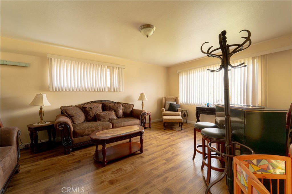 9221 Pico Vista Road Downey, CA 90240 - Photo 3 of 38 a living room with furniture a window and wooden floor