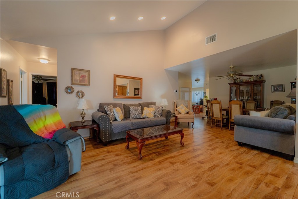 9221 Pico Vista Road Downey, CA 90240 - Photo 7 of 38 a living room with furniture a lamp and a window