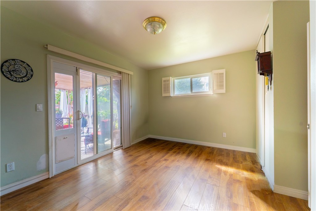 9221 Pico Vista Road Downey, CA 90240 - Photo 8 of 38 a view of an empty room with wooden floor and a window