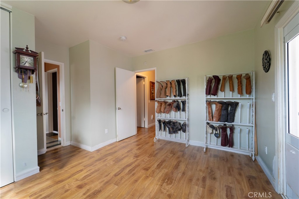 9221 Pico Vista Road Downey, CA 90240 - Photo 9 of 38 wooden floor in an empty room with a window and a kitchen