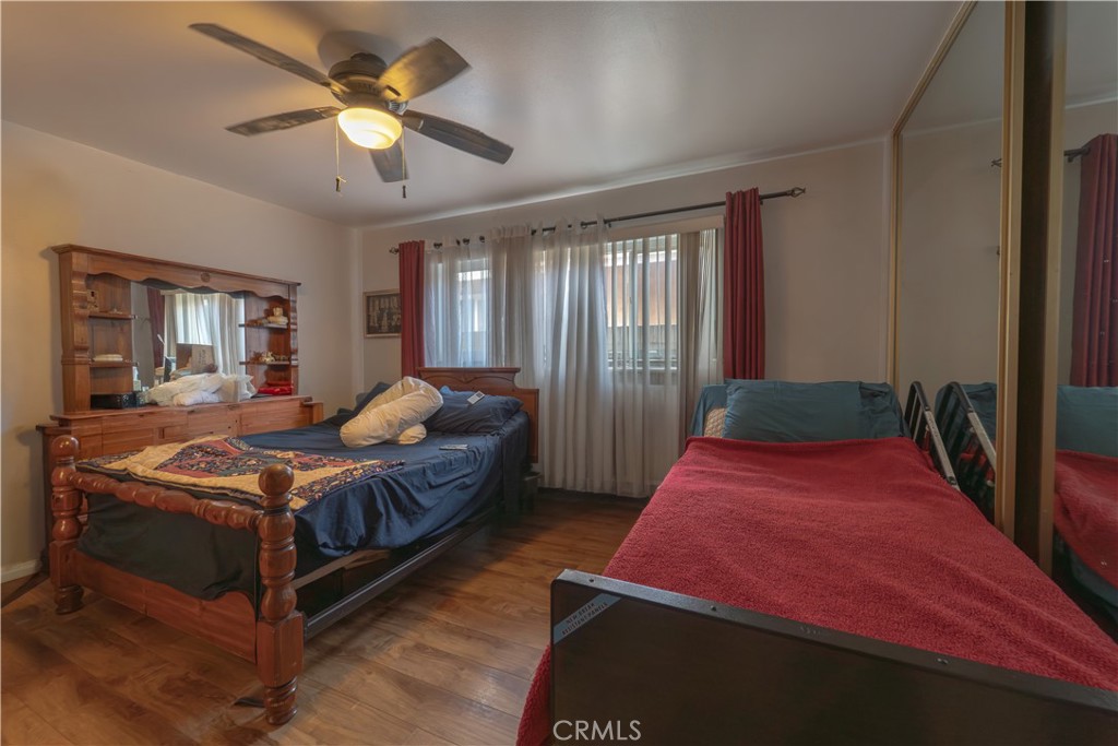 9221 Pico Vista Road Downey, CA 90240 - Photo 10 of 38 a bedroom with a large bed and a chandelier
