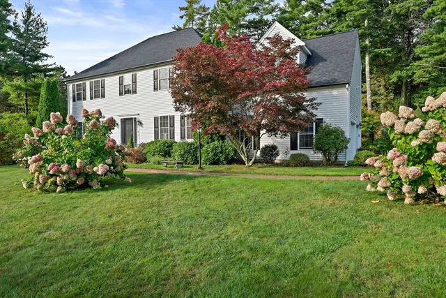 a front view of a house with garden