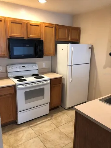 a kitchen with a appliances and a microwave