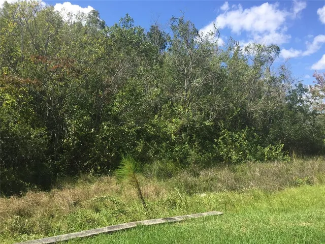 a view of a lake view with houses in background